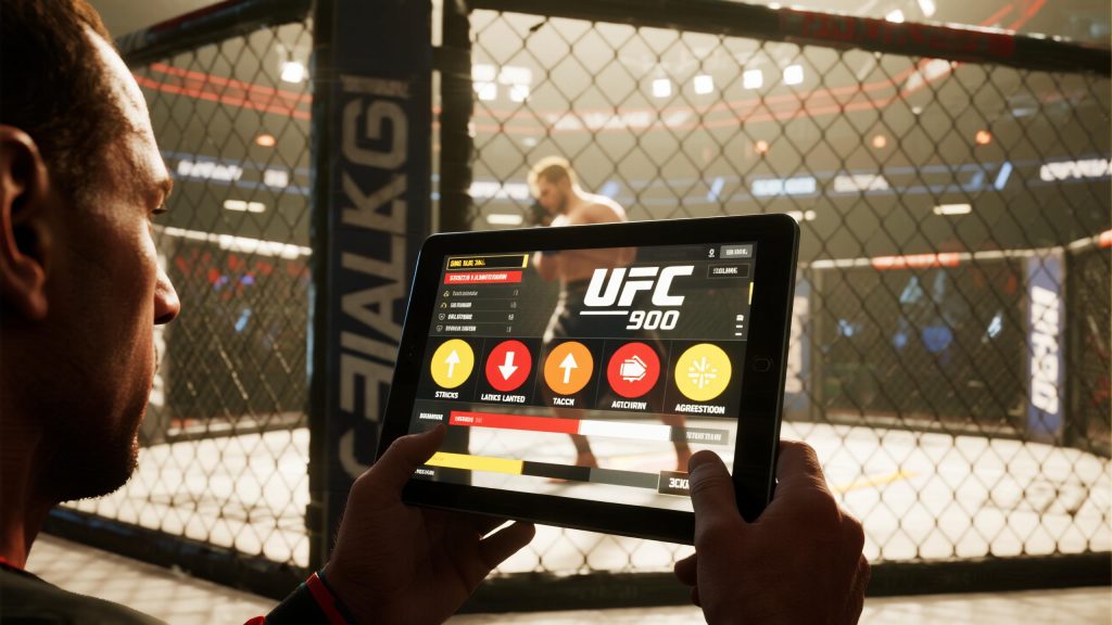 케이지 밖에서 태블릿으로 실시간 UFC 경기 데이터를 확인하는 장면